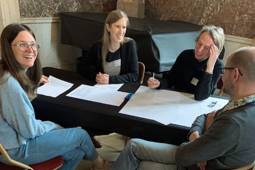 Knowledge Hub members laughing as they discuss the future of OS.