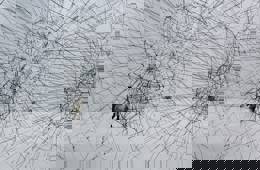 Foto van een kunstwerk bestaande uit drie doorschijnende zwarte bollen gemaakt van touwen. Ze zijn met elkaar verbonden als een soort netwerk. 