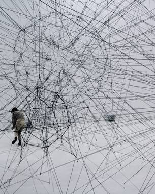 Photo of an artwork consisting of three translucent black spheres made from ropes. They are connected to each other like a kind of network.